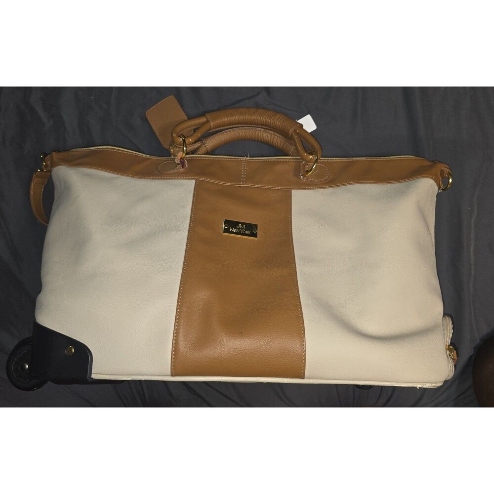 JM New York Tan faux leather luggage with wheels and tons of pockets!